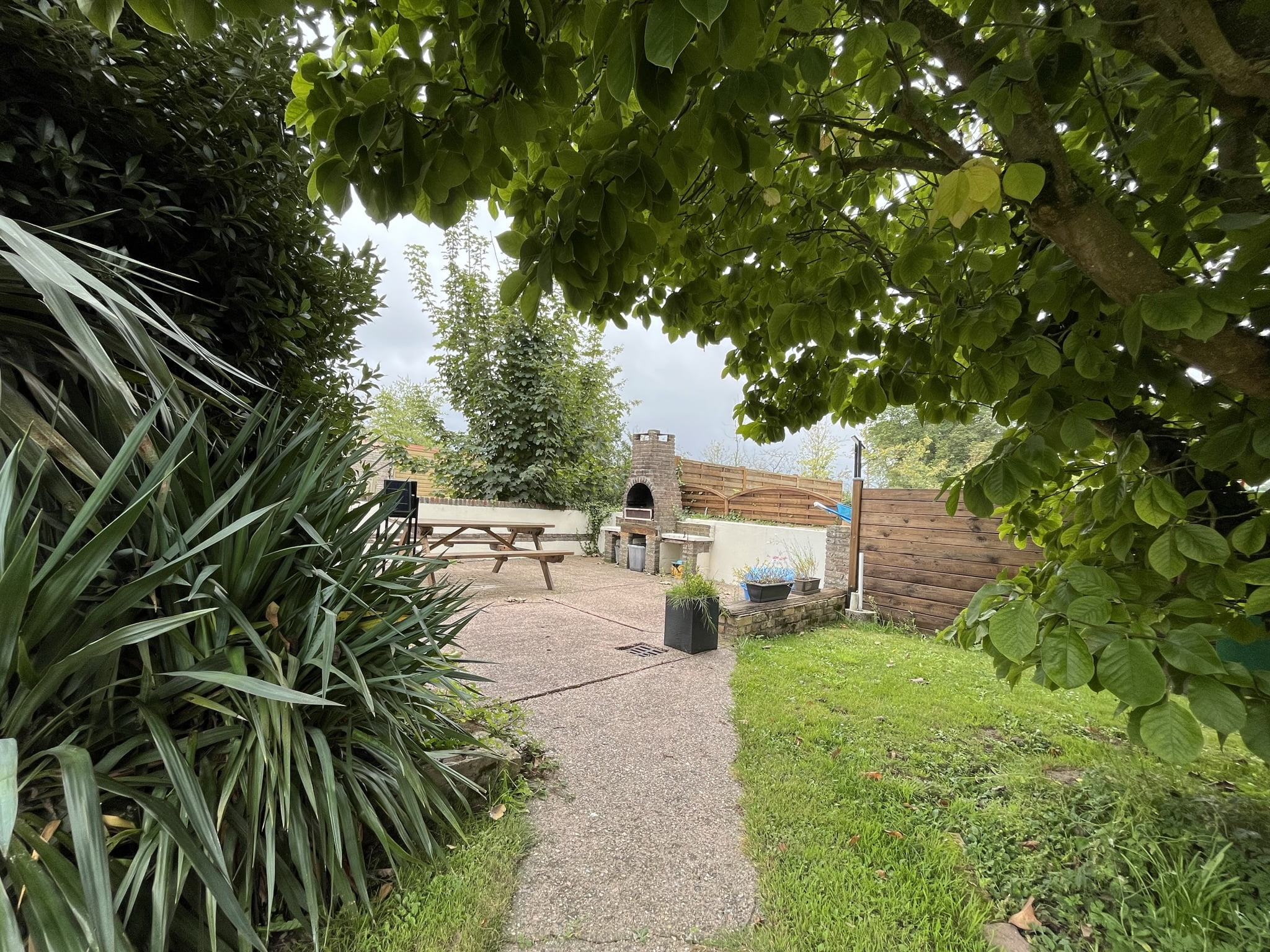 Barbecue extérieur en pierre avec une table de pique-nique.